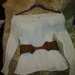 White off-the-shoulder shirt with belt and vest